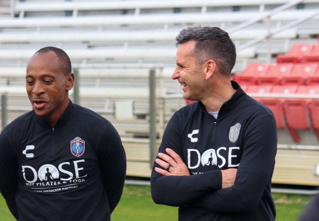 Head Coach Stephen Glass (right) and Leston Paul laugh at a 901 FC training session.